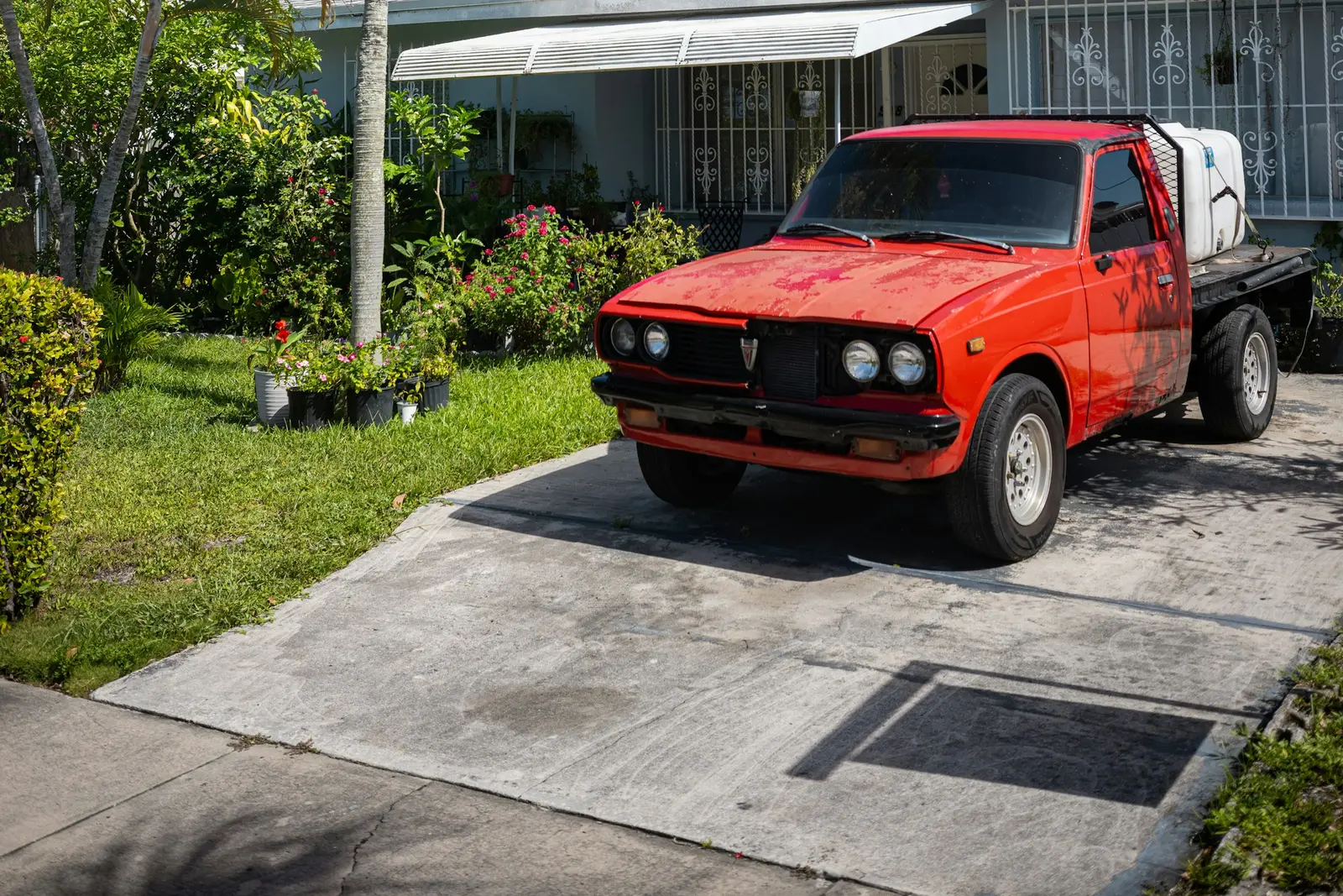 Single-story Florida home with a red pickup on a concrete driveway