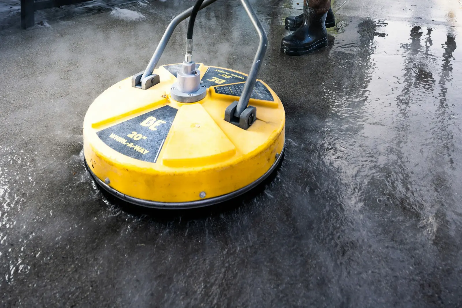 Yellow surface cleaner on freshly washed concrete